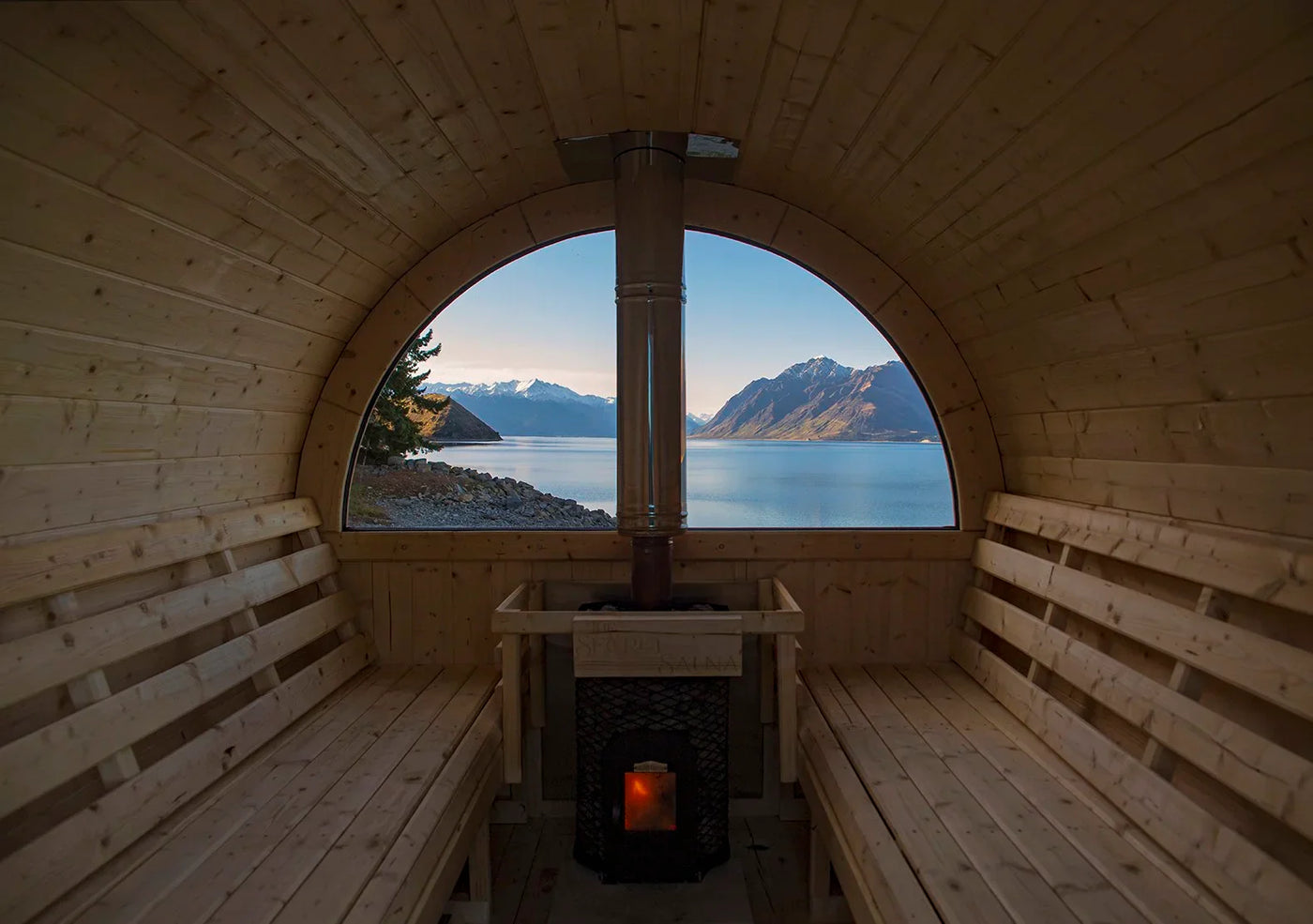 Barrel sauna interior looking out at mountains and lake — proven benefits of sauna use