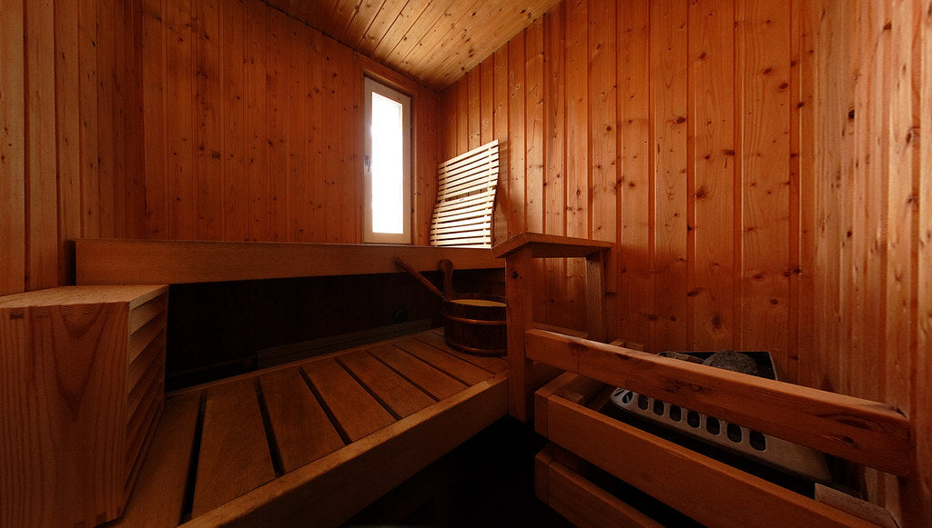 Traditional Finnish sauna interior with wooden benches — sauna safety tips