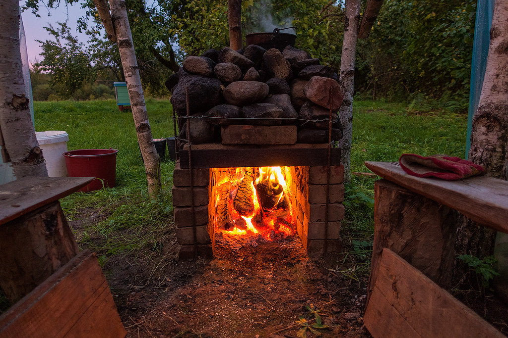 Outdoor wood-fired sauna stove at dusk — sauna traditions around the world